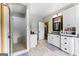 Bright bathroom with a glass shower, white subway tile, granite countertops, tile flooring, and white vanity with ample storage at 290 Weldon Rd, Fayetteville, GA 30215