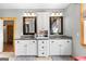 Bathroom with double vanity, granite countertops, framed mirrors, neutral decor, and tile flooring offering ample space at 290 Weldon Rd, Fayetteville, GA 30215