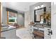 Bathroom with granite countertop vanity, framed mirror, natural light, and neutral colors, offering a serene and stylish space at 290 Weldon Rd, Fayetteville, GA 30215