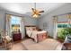 Cozy bedroom with hardwood floors, ceiling fan, and bright windows at 290 Weldon Rd, Fayetteville, GA 30215