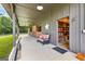 The spacious covered porch with comfortable seating gives a welcoming view of a landscaped pasture at 290 Weldon Rd, Fayetteville, GA 30215