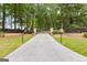 Long paved driveway lined with trees and manicured landscaping leading to property at 290 Weldon Rd, Fayetteville, GA 30215