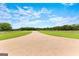 Long brick driveway leading to a property with lush greenery and trees at 290 Weldon Rd, Fayetteville, GA 30215