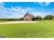 Stunning barn with covered parking and large driveway, beautifully situated on green acreage at 290 Weldon Rd, Fayetteville, GA 30215