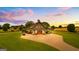 Striking barn exterior with covered parking, orange doors, and lovely green surroundings at 290 Weldon Rd, Fayetteville, GA 30215