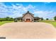Stunning exterior view of barn with covered parking and large driveway with brick pavers at 290 Weldon Rd, Fayetteville, GA 30215