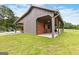 Well-maintained barn on lush green lawn, perfect for horses or storage, adding rural charm at 290 Weldon Rd, Fayetteville, GA 30215