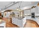 Large kitchen with a center island featuring counter seating, granite countertops, white cabinets, and rustic wood accents at 290 Weldon Rd, Fayetteville, GA 30215