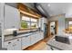 Well-lit kitchen with white cabinets, granite countertops, stainless steel appliances, and views of the outdoors from over the sink at 290 Weldon Rd, Fayetteville, GA 30215