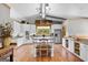 Bright kitchen with white cabinetry, granite countertops, stainless steel appliances, and island seating at 290 Weldon Rd, Fayetteville, GA 30215