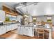 Bright kitchen featuring granite countertops, an island with seating, and wood flooring, creating a warm and inviting space at 290 Weldon Rd, Fayetteville, GA 30215