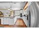 Spacious kitchen with granite countertops, stainless steel appliances, white cabinets, and an island for gathering and cooking at 290 Weldon Rd, Fayetteville, GA 30215