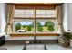 Kitchen window view of the lawn with trees and a blue sky over the stainless steel sink with white backsplash at 290 Weldon Rd, Fayetteville, GA 30215