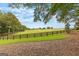 Expansive, picturesque land featuring green fields, a wooden fence, and mature trees at 290 Weldon Rd, Fayetteville, GA 30215
