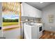 Bright laundry room featuring cabinetry, counter space, and a scenic view at 290 Weldon Rd, Fayetteville, GA 30215