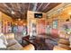 Inviting living room with rustic wood walls, exposed ceiling, and comfortable leather seating at 290 Weldon Rd, Fayetteville, GA 30215