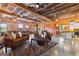 Spacious living room with wood walls, metal ceiling, chandelier, and leather sofas at 290 Weldon Rd, Fayetteville, GA 30215
