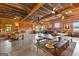 Open living space with concrete floors, wood walls, barn doors, farmhouse table, and area rug at 290 Weldon Rd, Fayetteville, GA 30215
