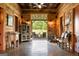 Open living space with wood walls, patio view, decorative furnishings, and concrete floors at 290 Weldon Rd, Fayetteville, GA 30215