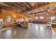Open living space with concrete floors, wood walls, barn doors, leather sofas, and farmhouse decor at 290 Weldon Rd, Fayetteville, GA 30215