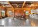 Open living space with concrete floors, wood walls, barn doors, farmhouse table, and island at 290 Weldon Rd, Fayetteville, GA 30215