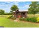Charming outbuilding with rustic details, wood shutters, and well-manicured landscaping at 290 Weldon Rd, Fayetteville, GA 30215