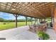 Outdoor patio showcases ample seating, a view of the pasture, and a rustic ceiling at 290 Weldon Rd, Fayetteville, GA 30215