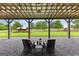 Covered patio with seating overlooking a green lawn and outbuildings at 290 Weldon Rd, Fayetteville, GA 30215