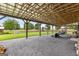 Covered patio with steel columns, gravel floor, and view of the lawn and chicken coop at 290 Weldon Rd, Fayetteville, GA 30215