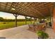 Covered patio with ample seating and scenic backyard views at 290 Weldon Rd, Fayetteville, GA 30215