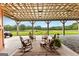 Covered patio with rocking chairs, overlooking a lush green lawn and wooded area at 290 Weldon Rd, Fayetteville, GA 30215