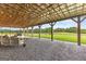 Covered patio with swing seat, gravel floor, steel posts, and an open view to the pasture at 290 Weldon Rd, Fayetteville, GA 30215