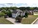 An aerial view of a two-story home with an attached garage, driveway, and lush landscaping at 313 Masters Club Blvd, Hampton, GA 30228