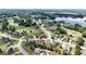 Aerial view highlights the neighborhood with a lake, golf course, winding streets, and lush landscaping at 313 Masters Club Blvd, Hampton, GA 30228