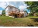 Large two-story home with a wooden deck and spacious green backyard at 313 Masters Club Blvd, Hampton, GA 30228