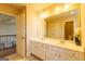 Bright bathroom with double vanity, white cabinetry, and tile flooring at 313 Masters Club Blvd, Hampton, GA 30228