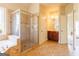 Primary bathroom featuring glass shower, soaking tub, and cherry wood vanity with updated fixtures at 313 Masters Club Blvd, Hampton, GA 30228