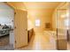 Bright bathroom featuring a soaking tub, tile flooring, and separate vanity area with neutral color palette at 313 Masters Club Blvd, Hampton, GA 30228