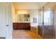 Bathroom features a soaking tub, cherry wood vanity, and a separate glass shower at 313 Masters Club Blvd, Hampton, GA 30228