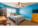 Cheerful bedroom with blue walls, sports decor, and a large window at 313 Masters Club Blvd, Hampton, GA 30228