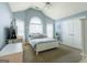 Light and airy bedroom with vaulted ceiling, a large window, and nautical decor at 313 Masters Club Blvd, Hampton, GA 30228