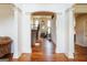 Grand foyer with hardwood floors, white columns, and a view of the staircase and living area at 313 Masters Club Blvd, Hampton, GA 30228