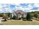 Beautiful two-story home featuring a well-manicured lawn and nicely landscaped front yard at 313 Masters Club Blvd, Hampton, GA 30228
