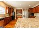 Spacious kitchen featuring granite countertops, stainless steel appliances and rich, dark wood cabinetry at 313 Masters Club Blvd, Hampton, GA 30228