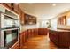 Gourmet kitchen boasts custom cabinetry, granite countertops, stainless steel appliances, and hardwood floors at 313 Masters Club Blvd, Hampton, GA 30228