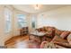 Cozy living room features hardwood floors, bay window, and comfortable seating arrangement at 313 Masters Club Blvd, Hampton, GA 30228