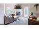 Inviting living room with fireplace, neutral tones, plush seating, and natural light at 313 Masters Club Blvd, Hampton, GA 30228