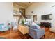 Spacious living room with hardwood floors, high ceilings, stylish furniture, and a staircase at 313 Masters Club Blvd, Hampton, GA 30228