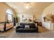 Bright main bedroom featuring carpet floors, a king bed and a sitting area at 313 Masters Club Blvd, Hampton, GA 30228