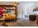 Luxurious main bedroom with a four-poster bed, a sitting area and a fireplace at 313 Masters Club Blvd, Hampton, GA 30228